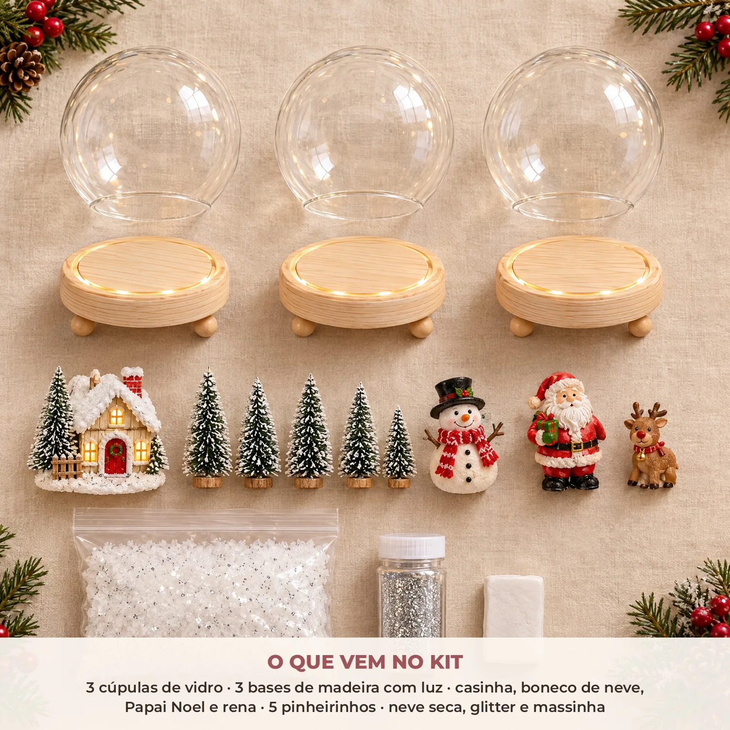 O que vem no kit: 3 cúpulas de vidro, 3 bases de madeira com luz, casinha, boneco de neve, Papai Noel, rena, 5 pinheirinhos, neve seca, glitter e massinha